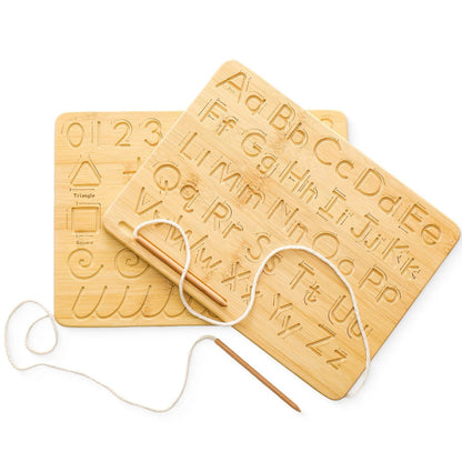 A pair of wooden Montessori tracing boards showing carved alphabets, numbers, shapes, and pre-writing patterns, with a wooden stylus and string included.