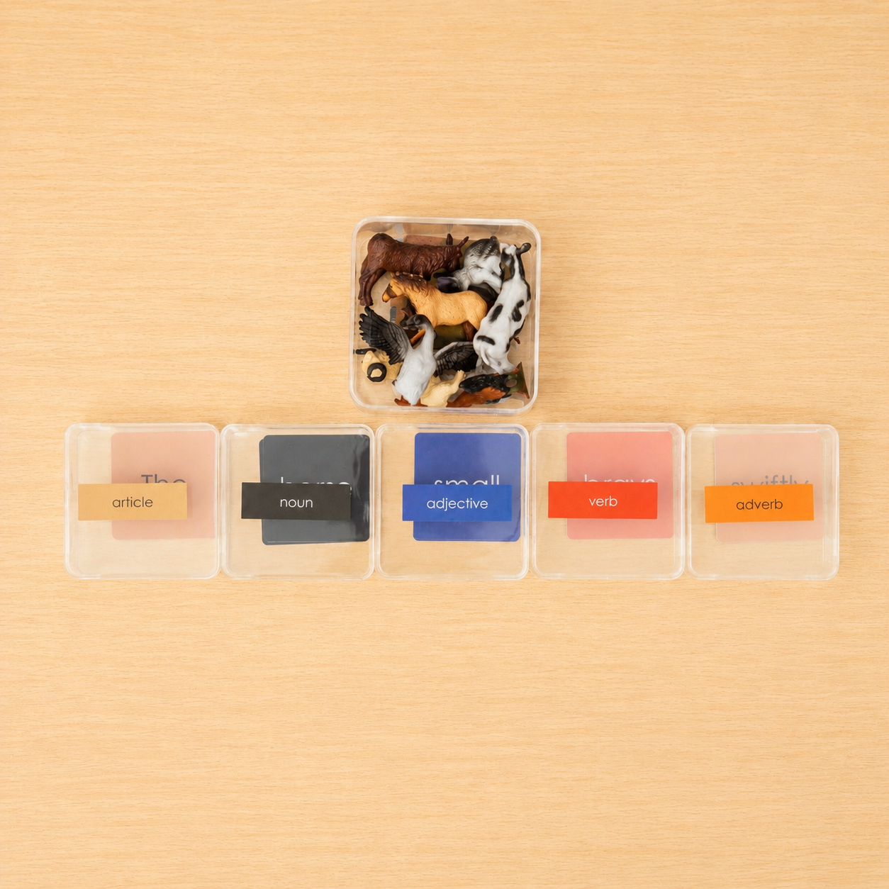 Montessori Non-Phonetic Farm Game clear compartment boxes showing animal figurines with article adjective noun verb and adverb cards