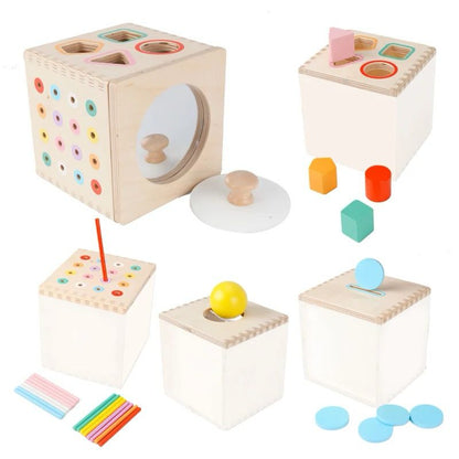 Wooden 5 in 1 activity cube showing shape sorting coin slot stick matching and mirror drum for toddler hand eye coordination