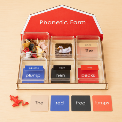 Montessori Phonetic Farm Game wooden barn display stand with colour-coded grammar cards and red frog figurine showing the sentence the red frog jumps