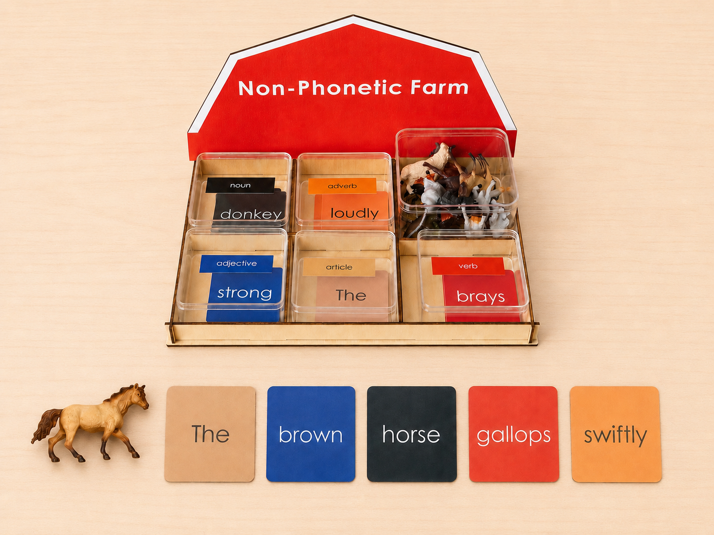 Montessori Non-Phonetic Farm Game wooden barn display stand with colour-coded grammar cards and horse figurine showing the sentence the brown horse gallops swiftly