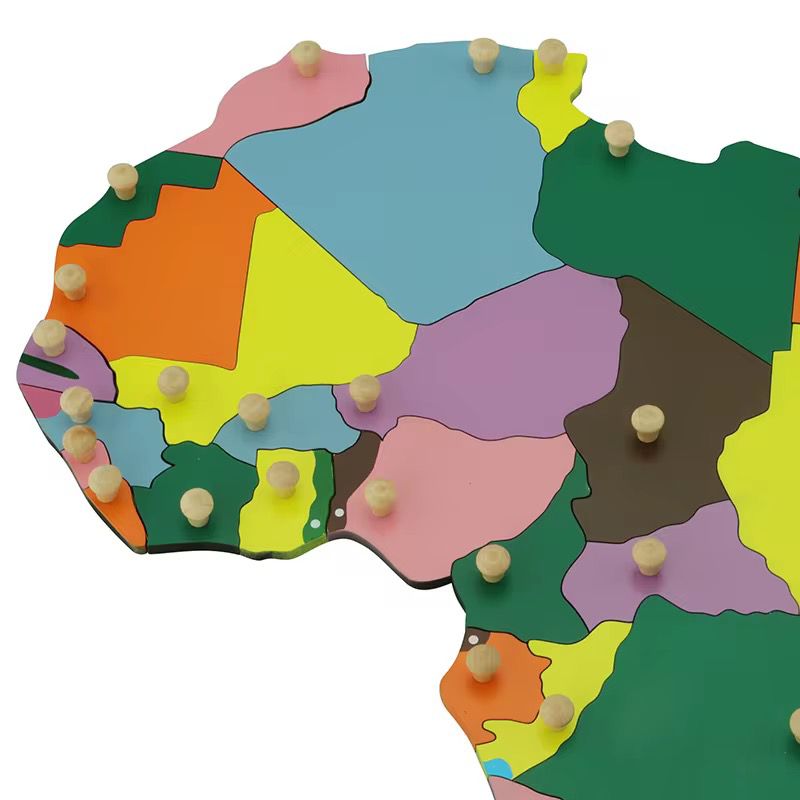 Close-up view of Montessori Africa puzzle map highlighting individual country pieces with wooden knobs for fine motor skills