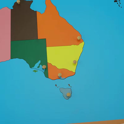 Close-up view of Montessori Australia puzzle map highlighting wooden state pieces with knobs for fine motor and map skills