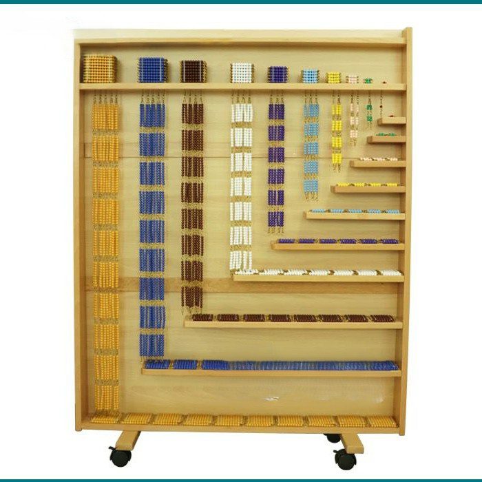Full Montessori bead material cabinet filled with golden, colored, and white bead bars, bead squares, and bead cubes arranged neatly on shelves.