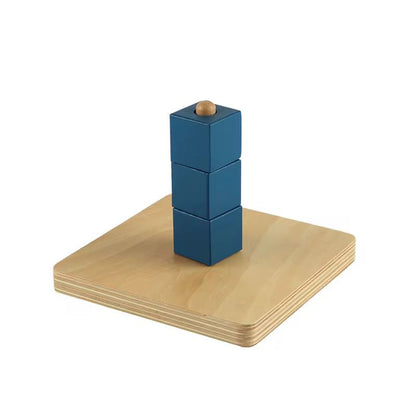 Montessori cubes on vertical dowel stacked for toddler fine motor coordination and controlled hand movement
