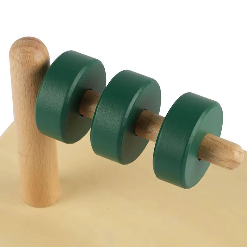 Montessori discs on horizontal dowel close-up showing wooden discs for toddler hand eye coordination and wrist rotation