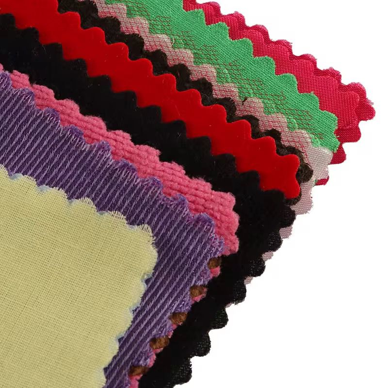 Close-up view of layered Montessori fabric swatches showing different textures and colors for tactile sensory learning.