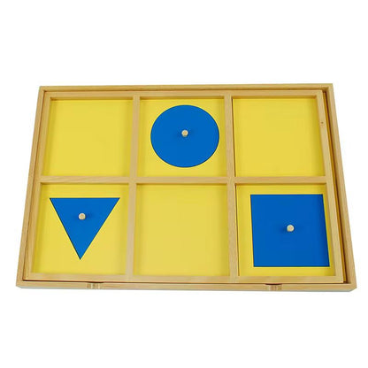 Top view of Montessori geometric demonstration tray with blue shapes on yellow background