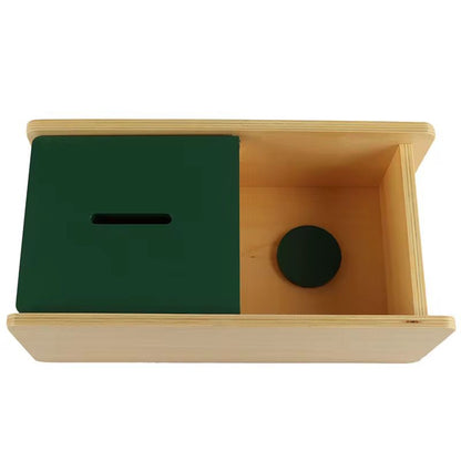 Top view of Montessori imbucare box showing coin inside for object permanence and hand eye coordination activity
