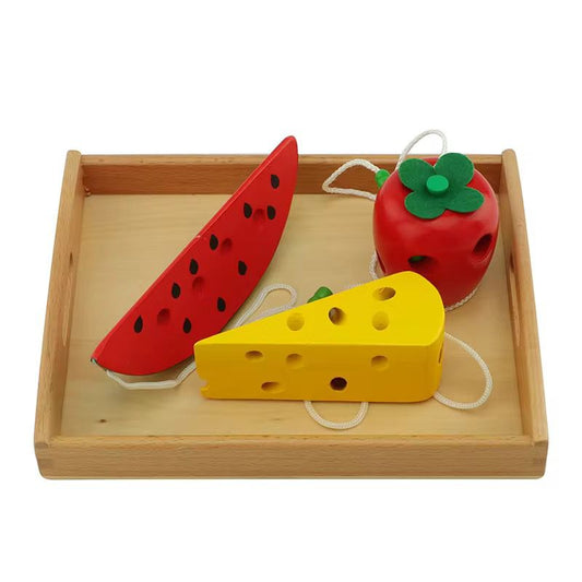 Montessori toddler lacing activity set with wooden fruit and cheese shapes for fine motor and practical life skill development
