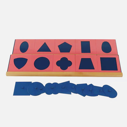 Individual blue metal inset geometric shapes removed from red frames for tracing activity
