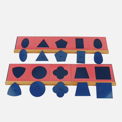 Montessori metal inset shapes placed outside frames for matching and fine motor skill development.