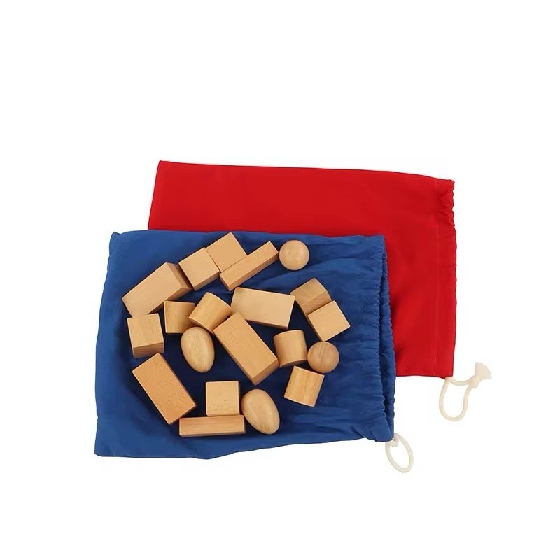 Montessori mystery bag activity with wooden shapes placed on blue sensory mat