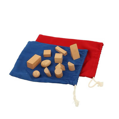 Wooden 3D geometric shapes displayed on red and blue Montessori stereo gnostic bags