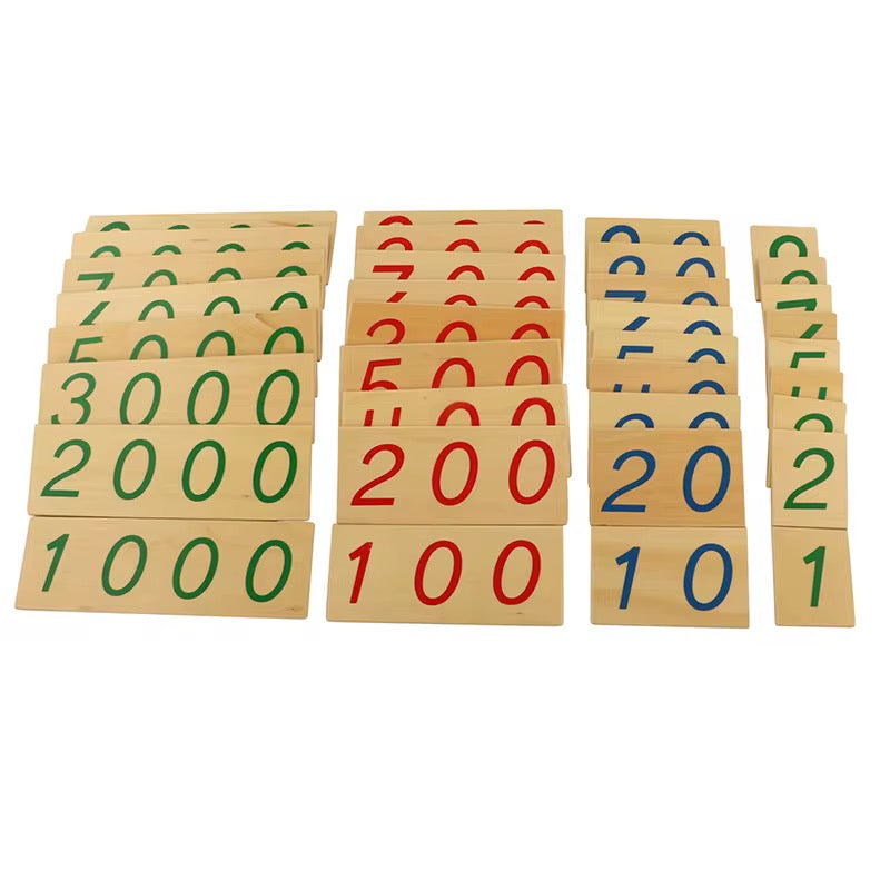 Full set of Montessori wooden number cards from 1 to 9000 displayed in color-coded place value groups.