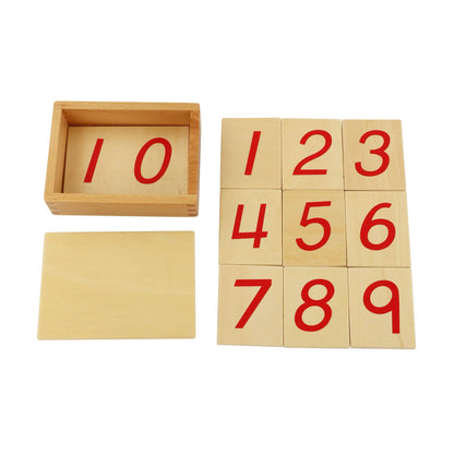 Montessori number cards shown beside an open wooden box, including numbers 1–9.