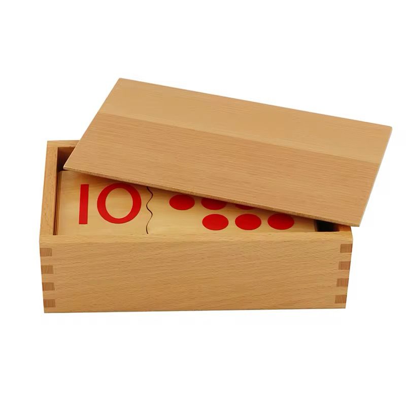 Wooden Montessori puzzle box with the lid partially closed over the number cards inside.