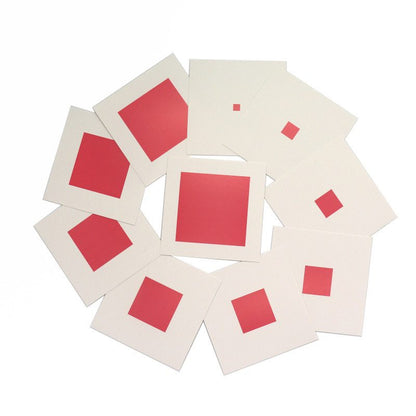 Top view of Montessori Pink Tower Control Cards showing different cube sizes printed on white cards