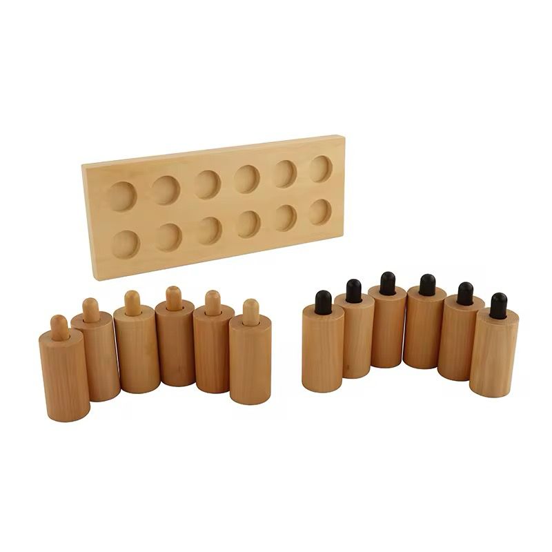 Loose Montessori pressure cylinders with wooden base showing light and heavy variations