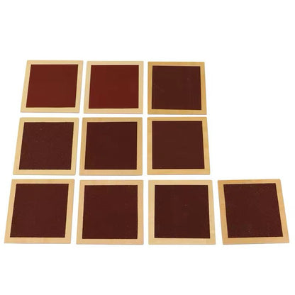 Montessori rough and smooth square tiles arranged for touch comparison