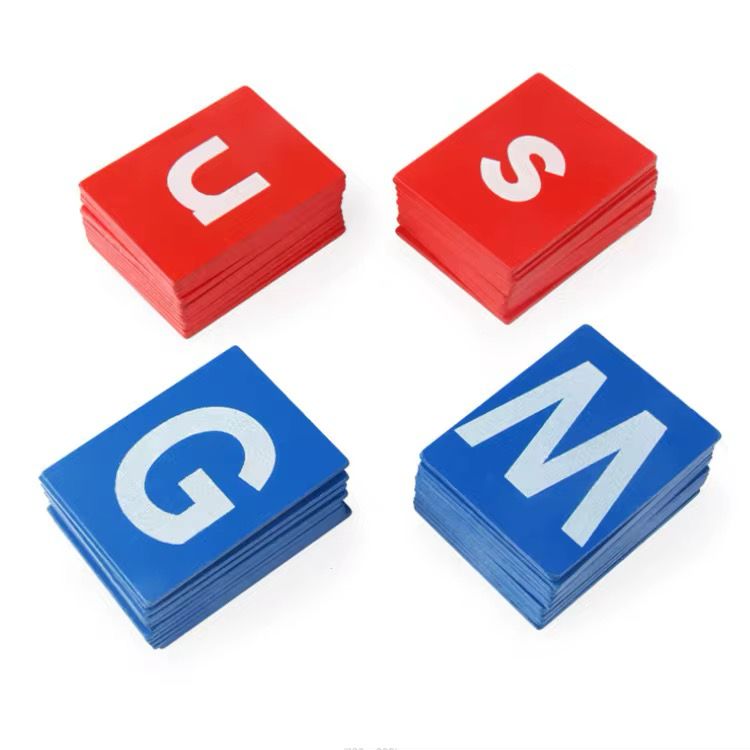 Stacks of uppercase and lowercase Montessori sandpaper letters in red and blue colors arranged separately.