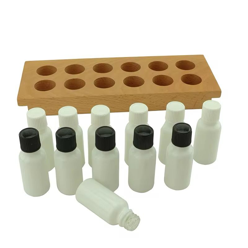 Top view of Montessori smelling bottles arranged on a wooden tray