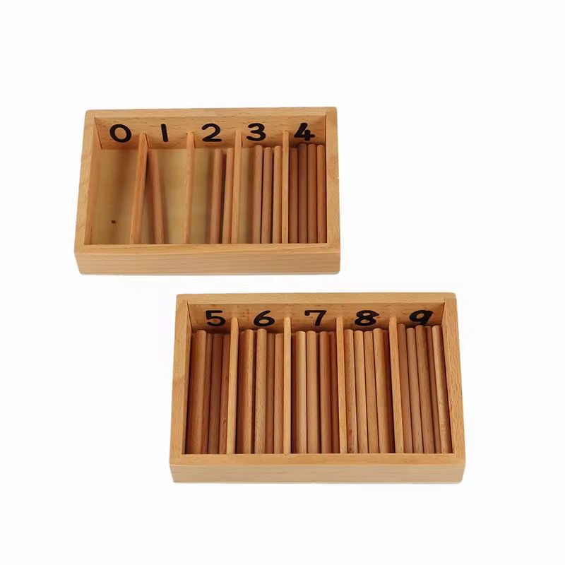 Montessori spindle box with wooden compartments labeled 0–4 and 5–9, containing wooden spindles used for hands-on counting practice.