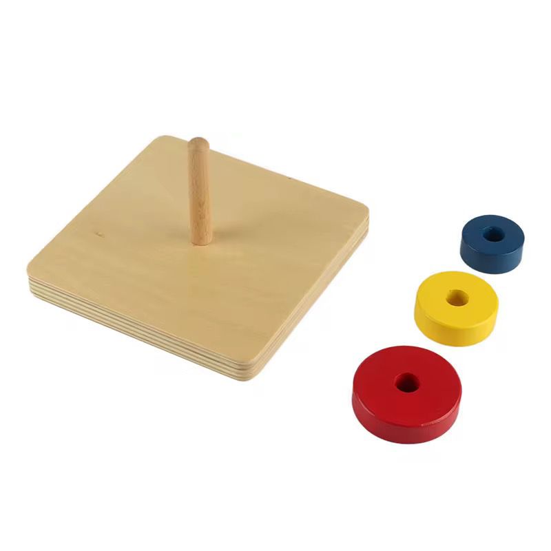 Montessori wooden stacking discs separated by size for toddler visual discrimination and motor planning