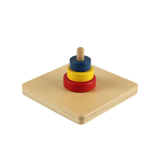 Montessori stacking discs on vertical dowel with red yellow and blue rings for toddler fine motor coordination