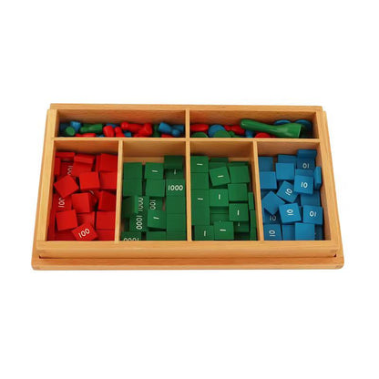 Montessori Stamp Game classroom set arranged in a wooden box with red, green, and blue number tiles and skittles for math operations.