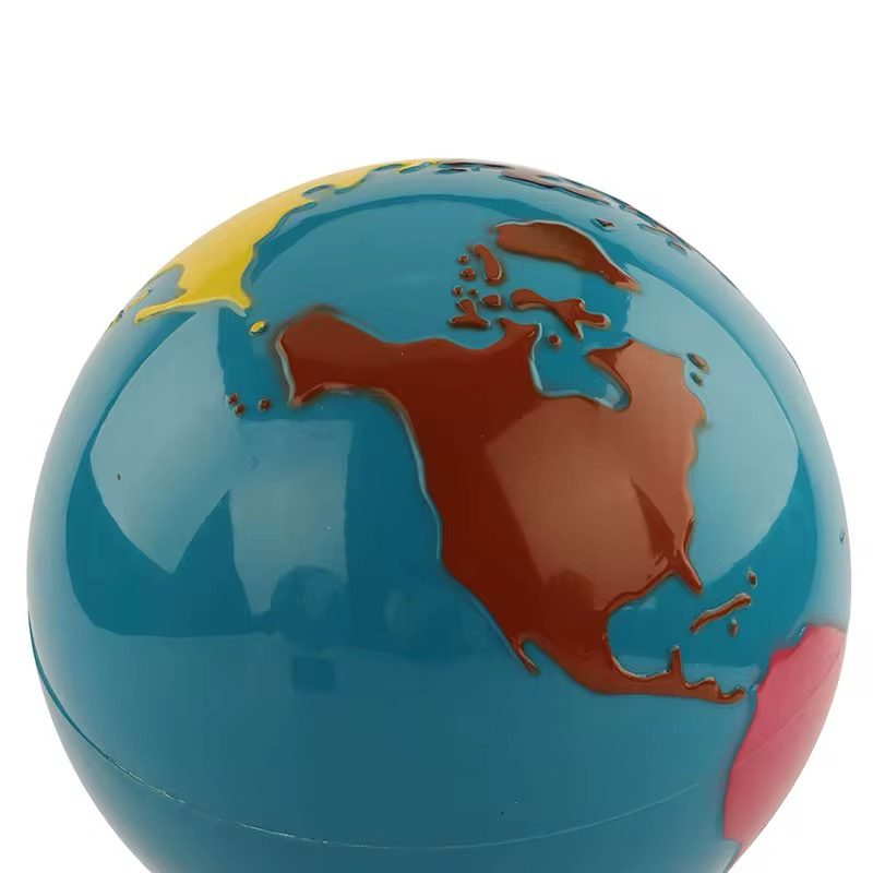 Close-up of Montessori-style globe showing raised continents for tactile geography exploration
