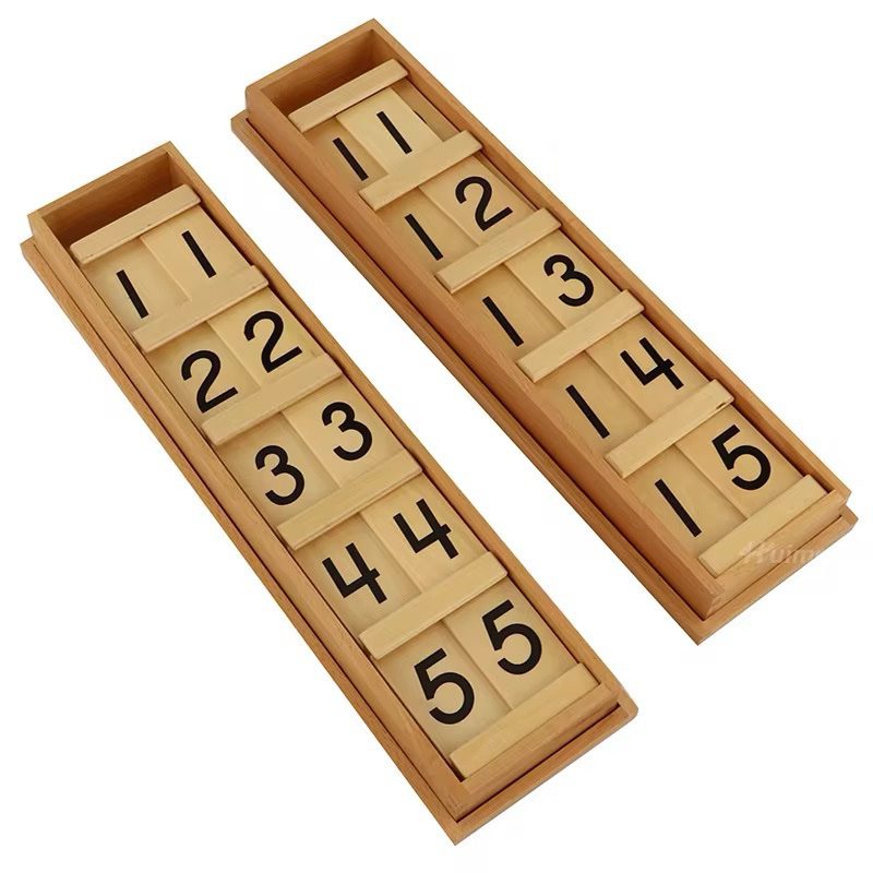 Two wooden trays displaying Montessori Teen and Ten Board tiles with numbers 1–9 for forming teen and tens numbers.
