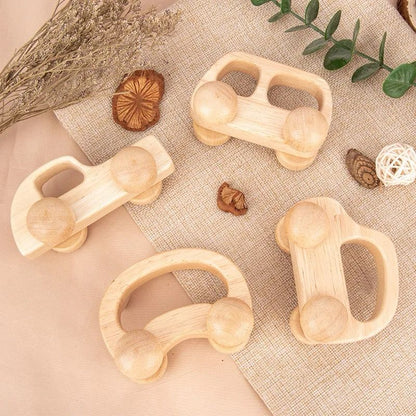 Natural wooden toy cars arranged on fabric background for infant sensory play and early motor development