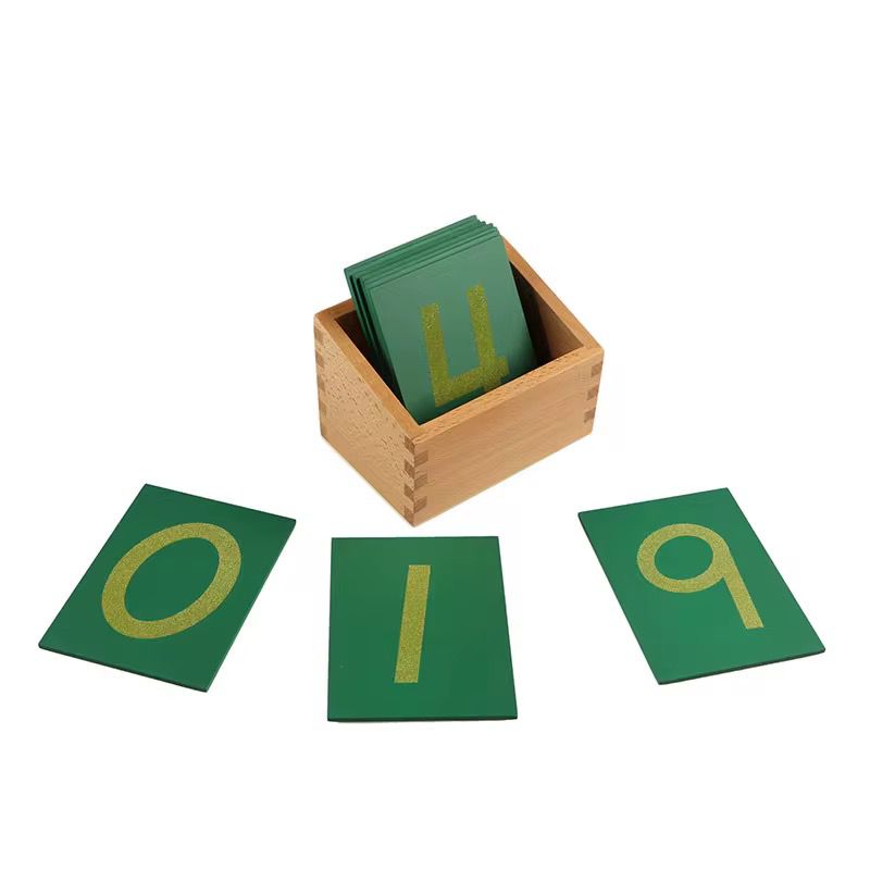 Sandpaper number cards from 0 to 9 arranged on a white surface for Montessori number recognition practice.