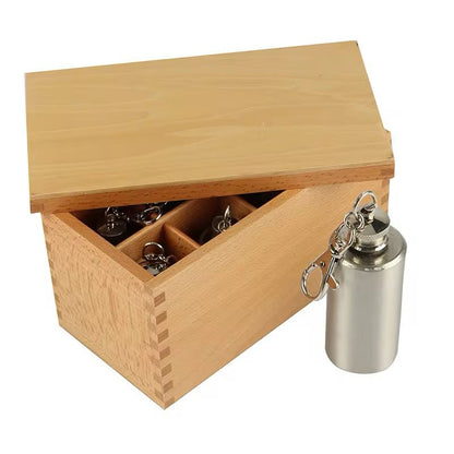 Thermic bottles shown with the wooden lid open, demonstrating storage and presentation of the Montessori material.