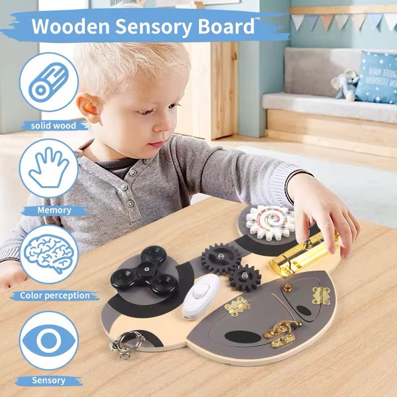 Toddler playing with wooden car busy board to develop sensory and fine motor skills
