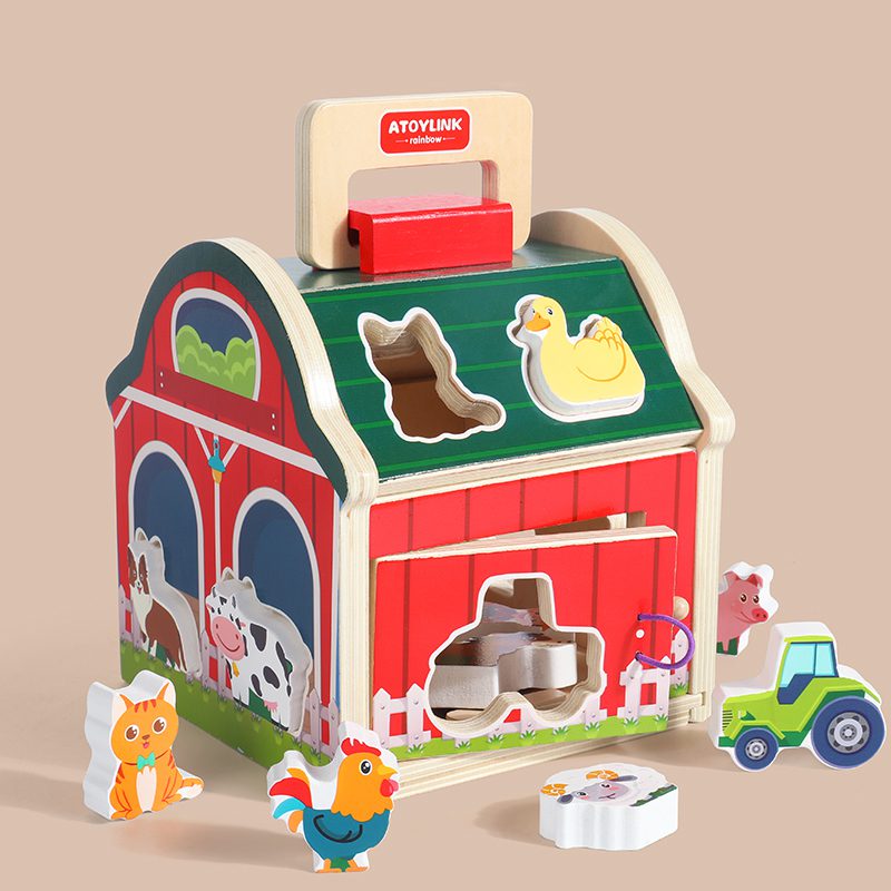 Front view of wooden farm shape sorting house with cow, duck, pig and tractor blocks