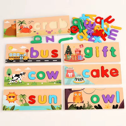 Wooden spelling puzzle boards arranged with loose colorful lowercase letters and words like cow, sun, bus, gift, cake, and owl.