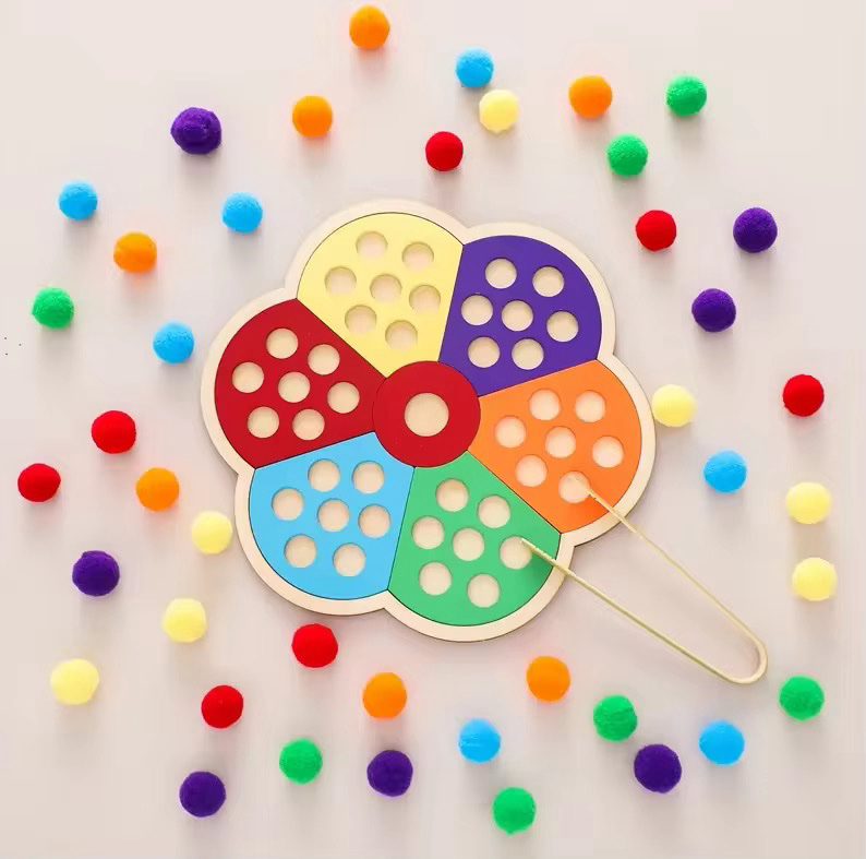 Flower shaped color sorting board with pom poms for toddlers to practice fine motor and color matching skills
