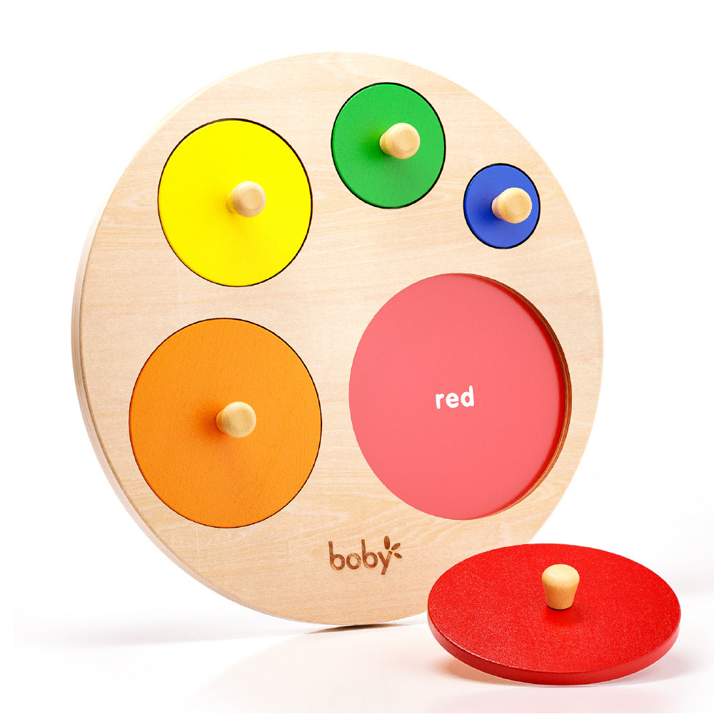 Montessori wooden circle size knob puzzle board with five colorful removable circles, designed to develop fine motor skills, size discrimination, and hand-eye coordination in toddlers.