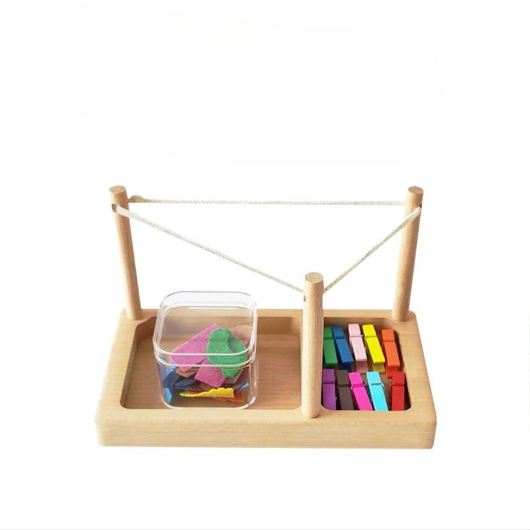 Montessori clothesline activity with wooden pegs and fabric pieces