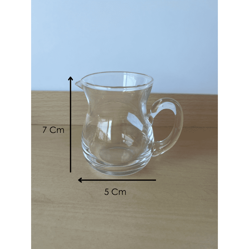 Close-up of Montessori glass pitcher designed for child-sized practical life pouring activities