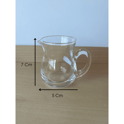 Close-up of Montessori glass pitcher designed for child-sized practical life pouring activities