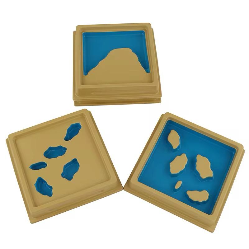 Montessori land and water form trays used in classroom geography activities for visual and tactile learning