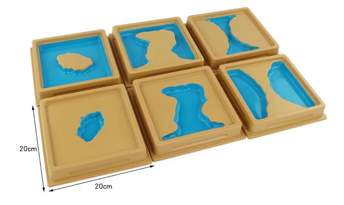 Montessori land and water form trays used to compare landforms and water bodies through hands-on geography learning