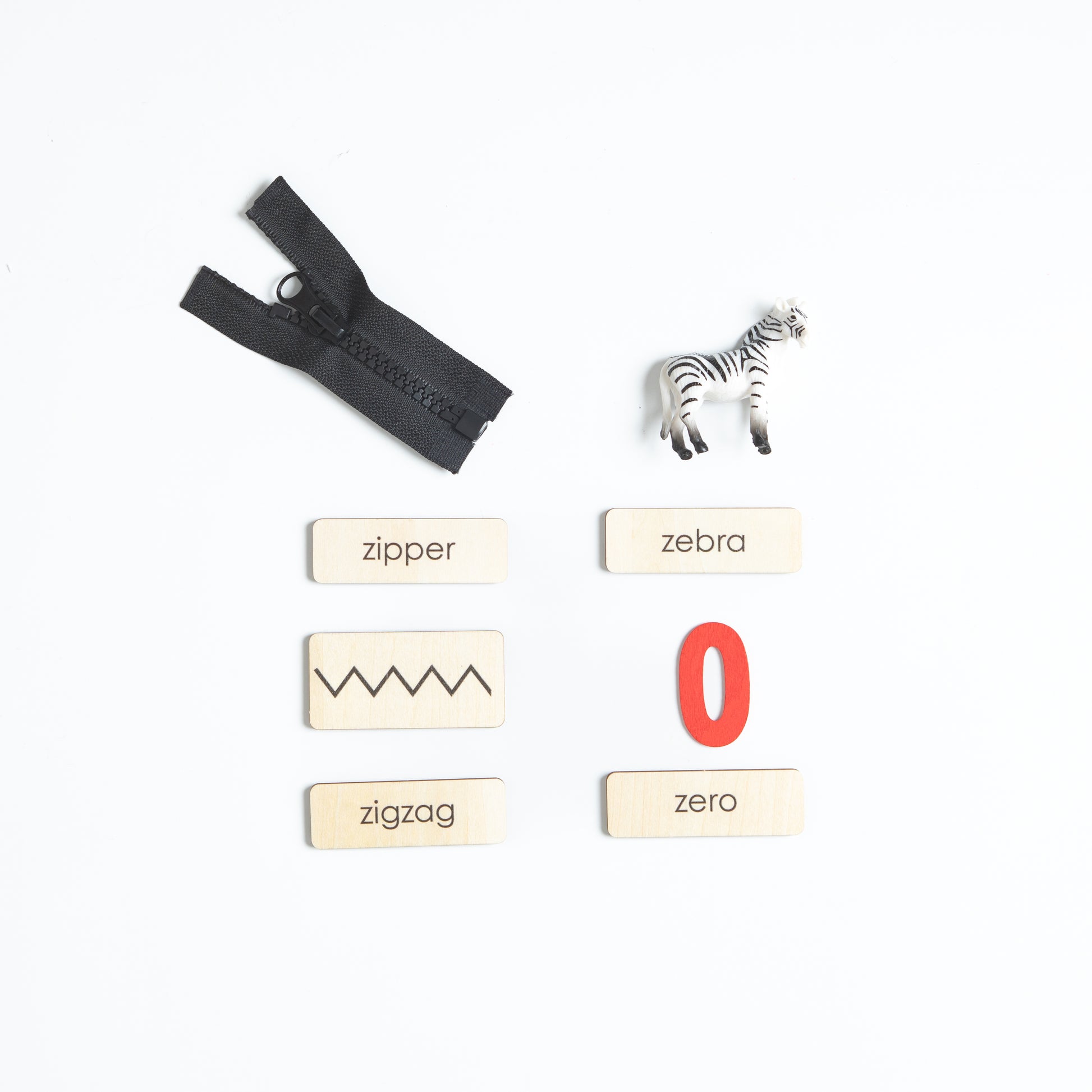 Montessori phonics objects for letters Y and Z with real miniature items
