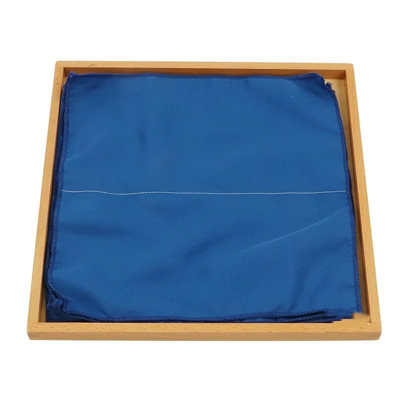 Montessori practical life folding activity cloth arranged on tray with stitched guide lines for learning folding skills