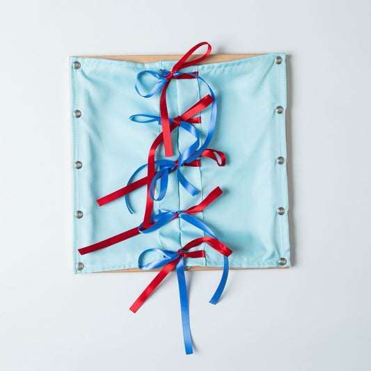 Montessori ribbon tying dressing frame with light blue fabric for bow tying practical life work