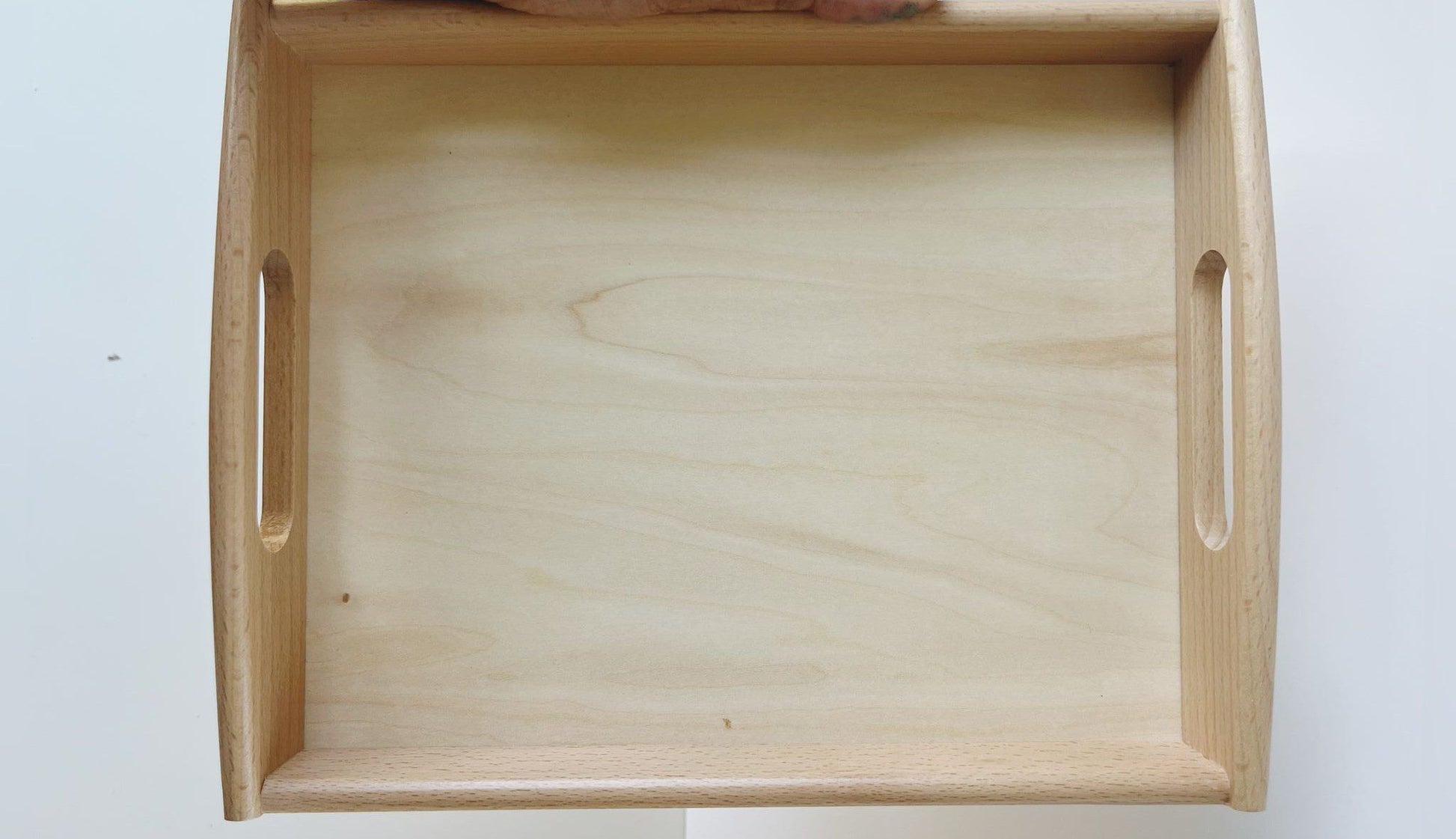 Angled view of Montessori wooden tray for classroom and home activities