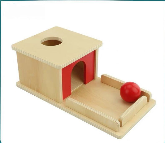 Infant Montessori object permanence activity with wooden ball